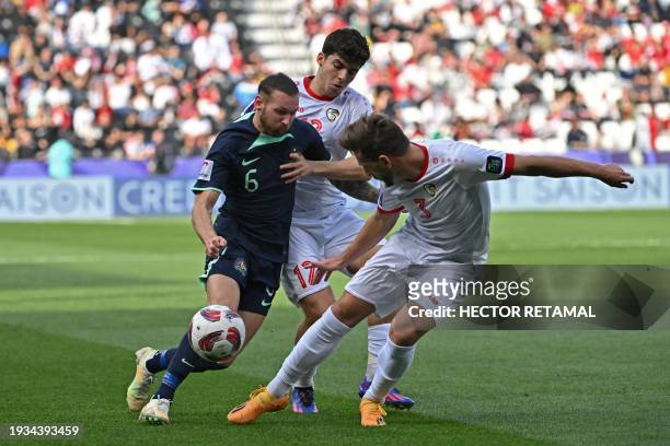 Syria's midfielder Ammar Ramadan and defender Moayad al-Ajaan vie for the ball against Australia's forward Martin Boyle during the Qatar 2023 AFC...