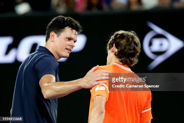 Milos Raonic of Canada embraces Alex de Minaur of Australia after retiring injured from his round one singles match during the 2024 Australian Open...