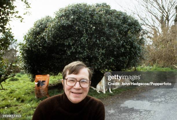 English writer and novelist Colin Wilson posed in the garden of his house in Cornwall, England in 1987.
