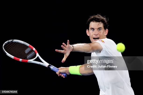 Dominic Thiem of Austria plays a forehand in their round one singles match against Felix Auger-Aliassime of Canada during the 2024 Australian Open at...