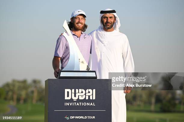 Tommy Fleetwood of England and Abdullah Al Naboodah pose with the trophy after Tommy Fleetwood won the Dubai Invitational at Dubai Creek Golf and...
