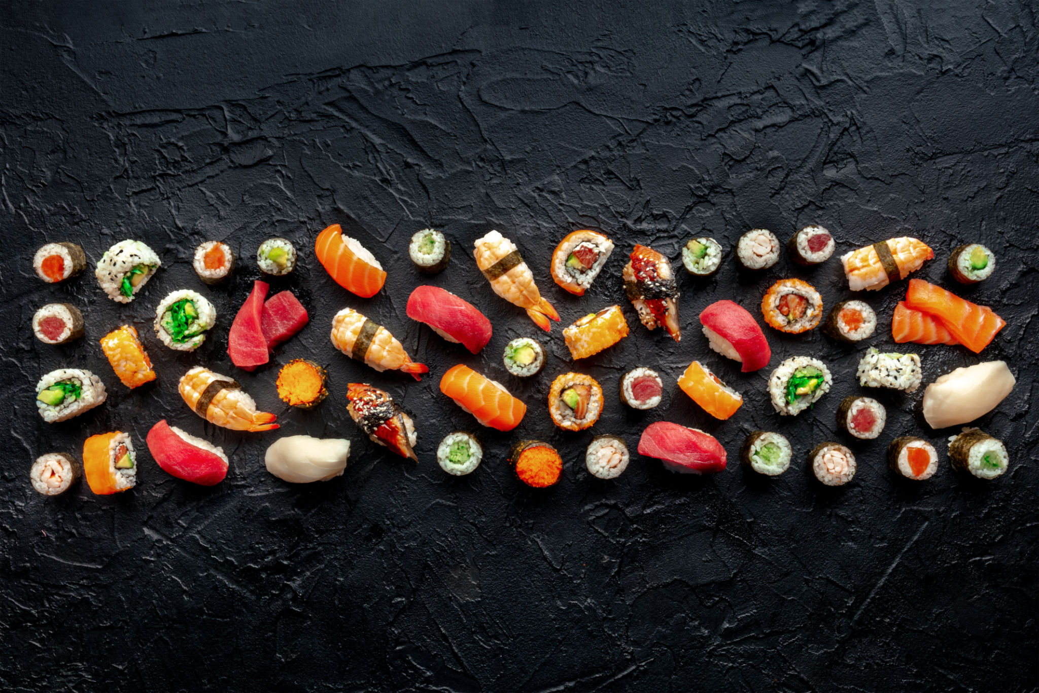 Sushi. An assortment of rolls, maki, nigiri etc, overhead flat lay composition Sushi. An assortment of rolls, maki, nigiri etc, overhead flat lay composition