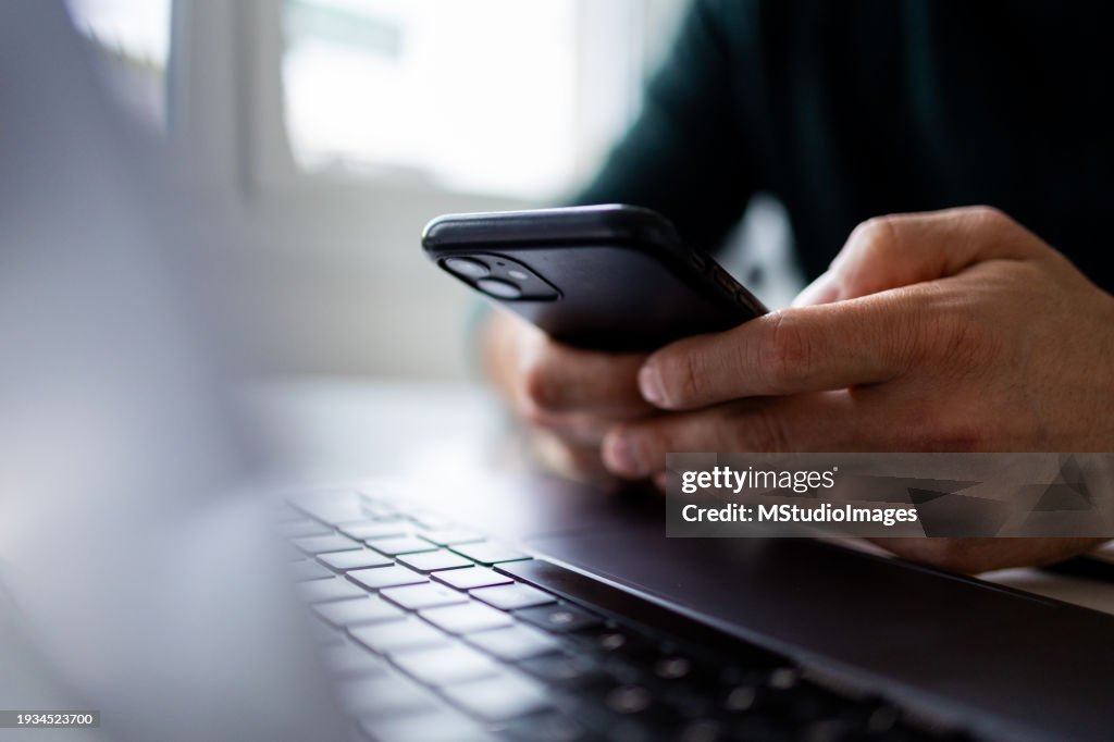 Close up on man hand using mobile phone