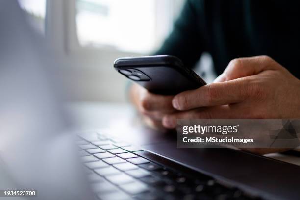 close up on man hand using mobile phone - man with iphone stock pictures, royalty-free photos & images