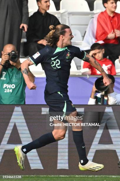 Australia's midfielder Jackson Irvine celebrates after scoring his team's first goal during the Qatar 2023 AFC Asian Cup Group B football match...