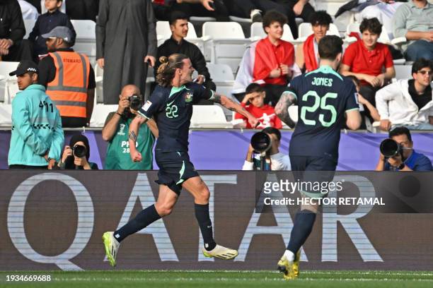 Australia's midfielder Jackson Irvine celebrates after scoring his team's first goal during the Qatar 2023 AFC Asian Cup Group B football match...