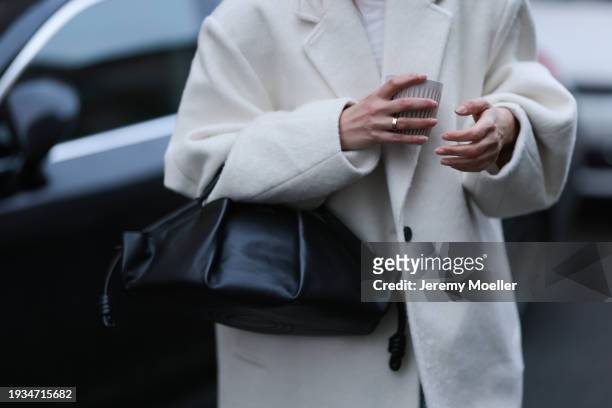 Anna Winter seen wearing Cartier Love gold ring, Weekday white cotton shirt, Source Unknown cream white wool oversized long coat, Loewe black leather...