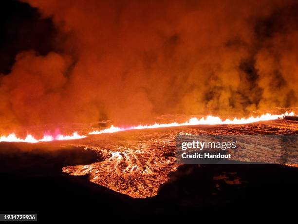 In this handout photo provided by the Iceland Coast Guard, lava is seen spewing from a volcano on Iceland's Reykjanes Peninsula after its eruption on...