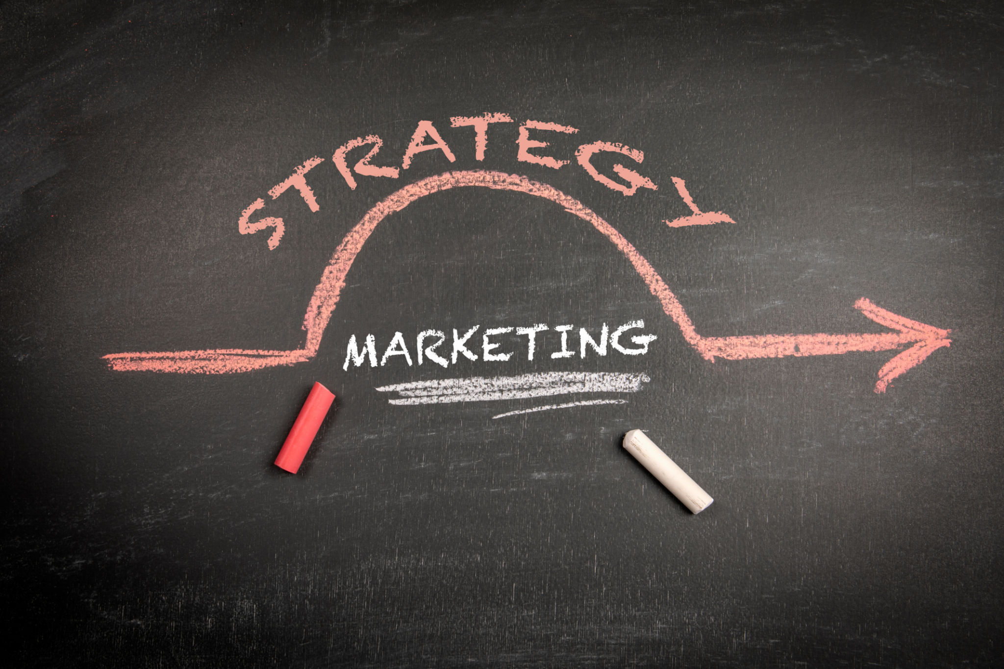 Marketing Strategy Concept. Text on a black chalkboard background Marketing Strategy Concept. Text on a black chalkboard background