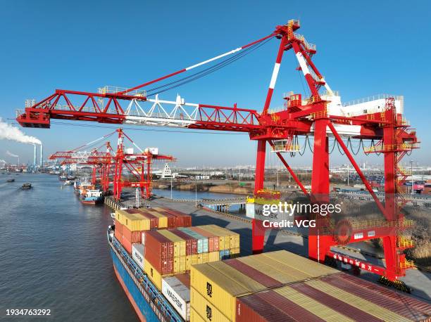 Cargo ships loaded with containers are berthed at the container terminal of Yangzhou Port on January 15, 2024 in Yangzhou, Jiangsu Province of China.