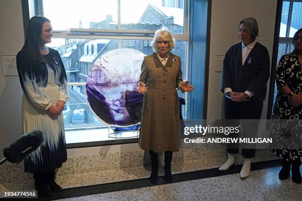 Britain's Queen Camilla reacts during a visit to Aberdeen Art Gallery, where she opened the gallery's 'Safe Space' as part of an initiative to...