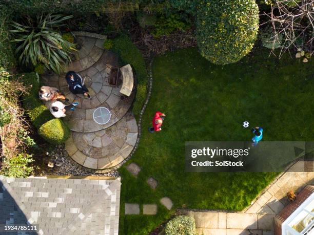 father and son football fun - manicured lawn from above stock pictures, royalty-free photos & images