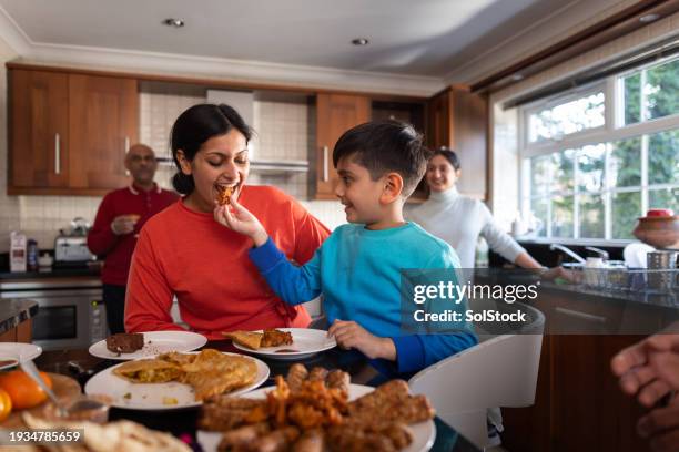 sharing is caring at home - real family stock pictures, royalty-free photos & images