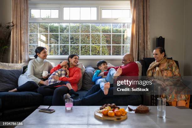 chilled days at home with the family - pakistani people stock pictures, royalty-free photos & images