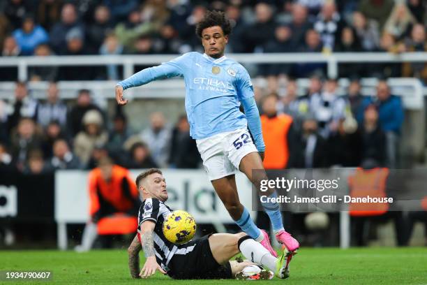 Oscar Bobb of Manchester City evades the challenge of Kieran Trippier of Newcastle United during the Premier League match between Newcastle United...