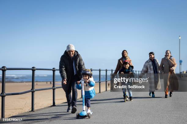 family adventures on the promenade - elderly scooter stock pictures, royalty-free photos & images