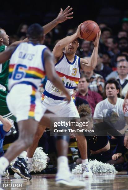 Mahmoud Abdul-Rauf, Point Guard for the Denver Nuggets looks to pass the basketball to Walter Davis during the NBA Midwest Division basketball game...