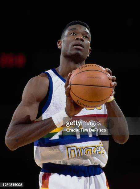 Dikembe Mutombo, Center for the Denver Nuggets prepares to make a free throw during the NBA Midwest Division basketball game against the Houston...