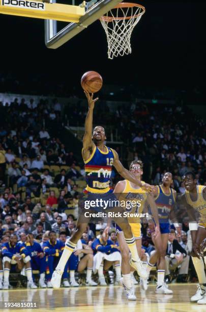 Fat Lever, Shooting Guard and Point Guard for the Denver Nuggets attempts a layup shot to the basket during the NBA Pacific Division basketball game...