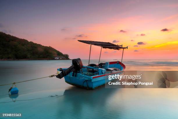 thai fishing boat used as a vehicle for finding fish in the sea at burning sky during sunrise/sunset - ship on fire stock pictures, royalty-free photos & images