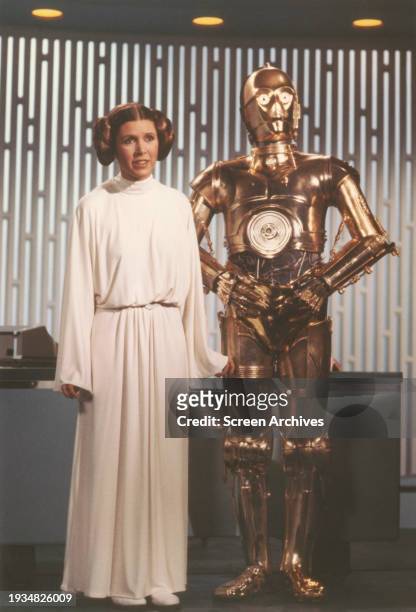 Carrie Fisher as Princess Leia and Anthony Daniels as C-3PO in a scene from the 1977 film 'Star Wars A New Hope'.