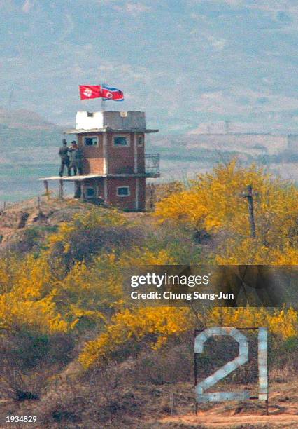North Korean soldiers stands at a guard post, decorated with flags marking the 91st anniversary of the late North Korean leader Kim Il Sung's...
