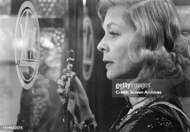 Lauren Bacall holding dagger in a scene from the 1974 film version 'Murder on the Orient Express'.