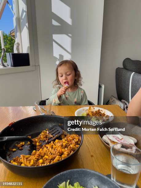 a child eating ice cream after meal - fusilli stockfoto's en -beelden