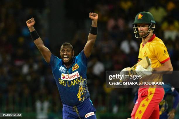 Sri Lanka's Angelo Mathews celebrates after taking the wicket of Zimbabwe's Craig Ervine during the third and final Twenty20 international cricket...