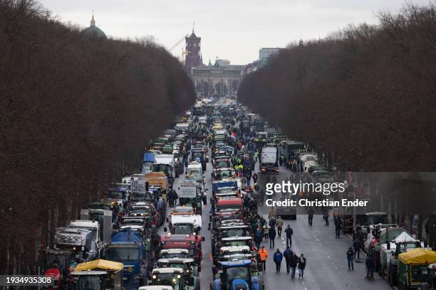 Protesting farmers depart with their tractors after attending a large-scale demonstration in front of the Brandenburg Gate on January 15, 2024 in...