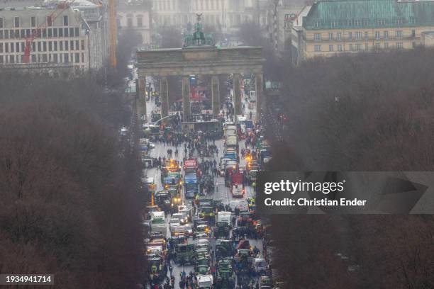 Protesting farmers depart with their tractors after attending a large-scale demonstration in front of the Brandenburg Gate on January 15, 2024 in...