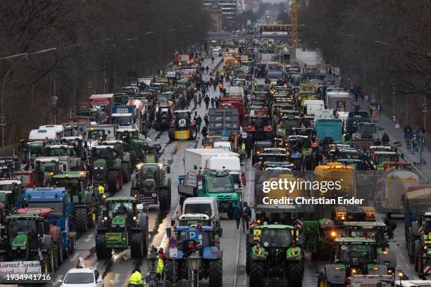 Protesting farmers depart with their tractors after attending a large-scale demonstration in front of the Brandenburg Gate on January 15, 2024 in...