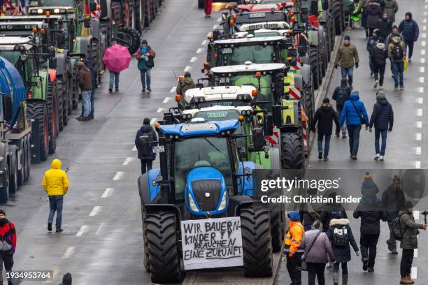 Protesting farmers depart with their tractors after attending a large-scale demonstration in front of the Brandenburg Gate on January 15, 2024 in...