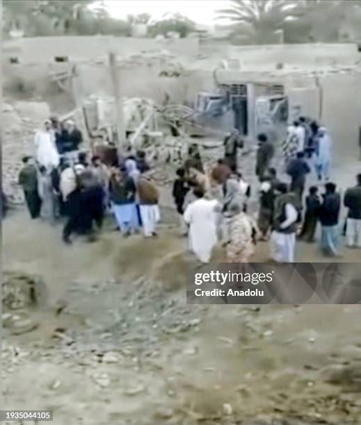 Screen grab captured from a video shows people at the site as Iran announces that 9 people, including 3 women and 4 children, died in the missile...