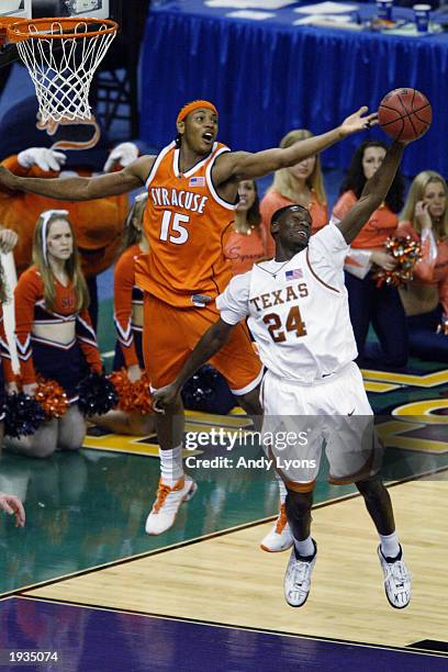 Carmelo Anthony of the Syracuse University Orangeman and Royal Ivey of the University of Texas at Austin Longhorns attempt to rebound during the...