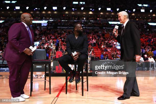 Miami Heat president Pat Riley and former Miami Heat player Dwayne Wade address the crowd during a Hall of Fame ceremony at halftime of a game...