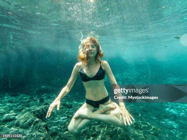 woman floating underwater, letting go - yoga levitation stock pictures, royalty-free photos & images