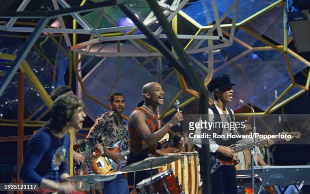 British soul group Hot Chocolate perform on the set of a pop music television show in London circa 1970. Members of the group are, from left, drummer...
