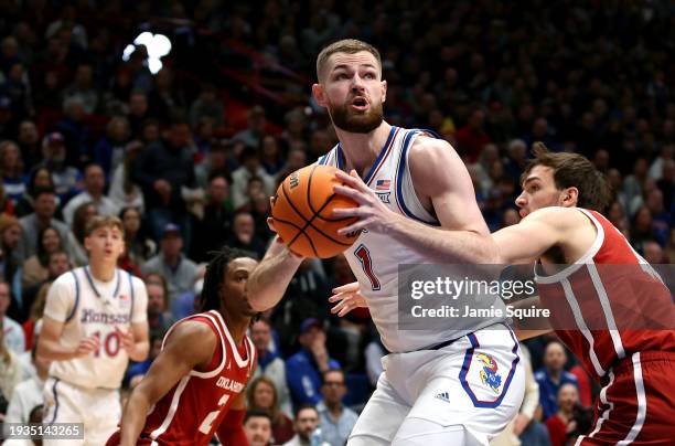 Hunter Dickinson of the Kansas Jayhawks shoots over Sam Godwin of the Oklahoma Sooners during the 1st half of the game at Allen Fieldhouse on January...