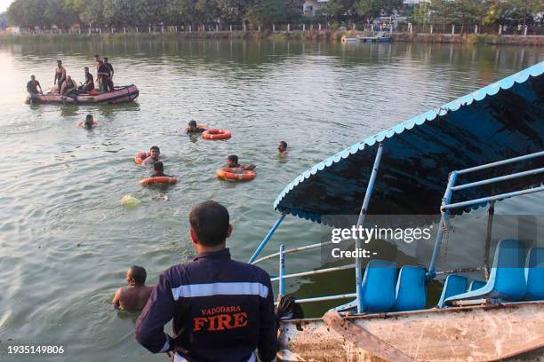 Members of Vadodara Fire and Emergency Services conduct search and rescue after a boat capsized at Harni Lake in Vadodara on January 18, 2024. At...