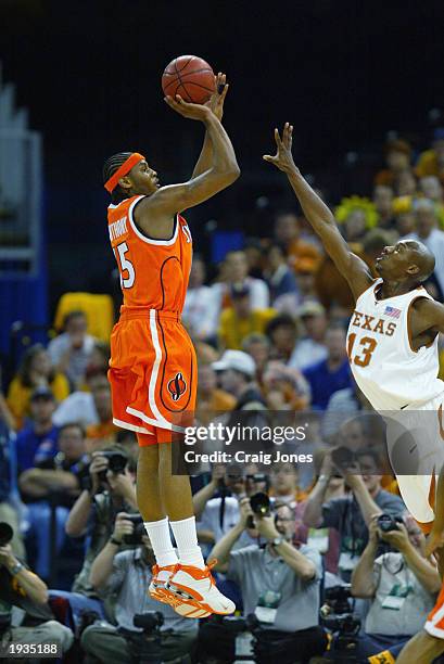 Carmelo Anthony of the Syracuse University Orangeman shoots over Sydmill Harris of the University of Texas at Austin Longhorns during the semifinal...