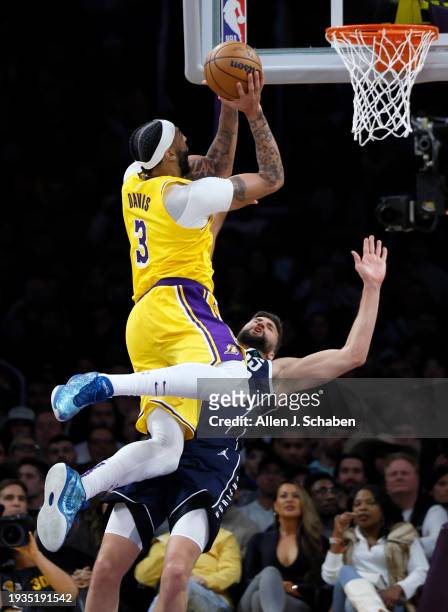 Los Angeles, CA Lakers forward Anthony Davis, #3, left, goes up for a shot while being fouled by Mavericks power forward Maxi Kleber, #42 in the...