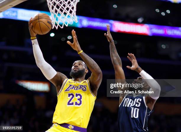 Los Angeles, CA Lakers forward LeBron James, #23, left, goes up for a basket as Mavericks small forward Tim Hardaway Jr., #10 defends in the first...