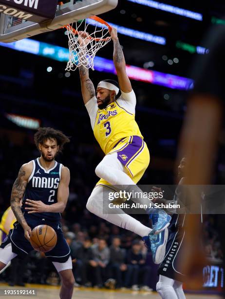 Los Angeles, CA Lakers forward Anthony Davis, #3, right, does a two-handed dunk over Mavericks power forward Dereck Lively II, #2, in the first half...