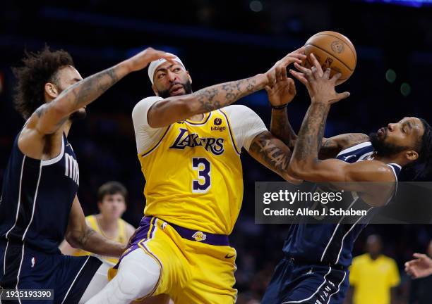 Los Angeles, CA Lakers forward Anthony Davis, #3, center, battles Mavericks power forward Dereck Lively II, #2, left, and forward Derrick Jones Jr.,...