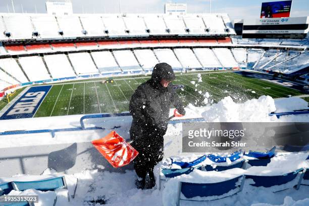Bryan Bremer shovels snow before the AFC Wild Card playoff game between the Buffalo Bills and Pittsburgh Steelers at Highmark Stadium on January 15,...