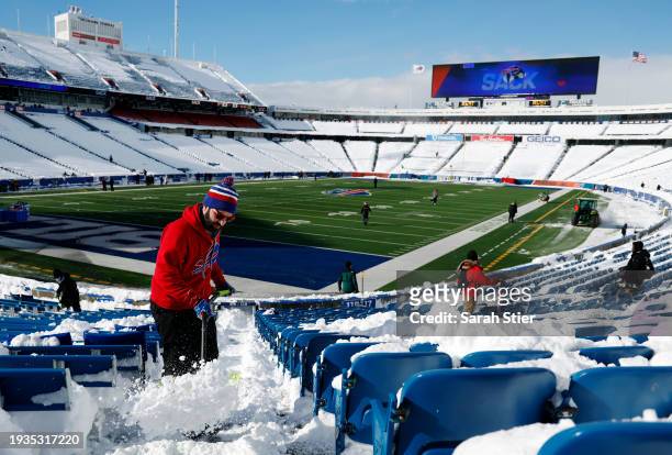 Rob Limoncelli shovels snow before the AFC Wild Card playoff game between the Buffalo Bills and Pittsburgh Steelers at Highmark Stadium on January...