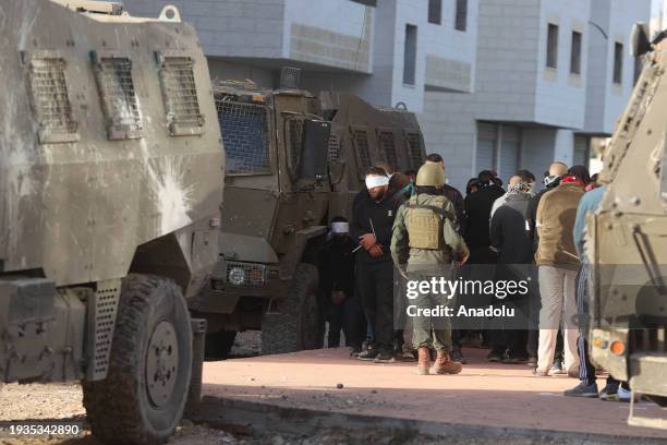 Israeli forces detain a number of Palestinians as they raid Tulkarm refugee camp in Tulkarm, West Bank on January 18, 2024.