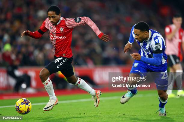 Kyle Walker-Peters of Southampton is put under pressure by Akinlolu Famewo of Sheffield Wednesday during the Sky Bet Championship match between...