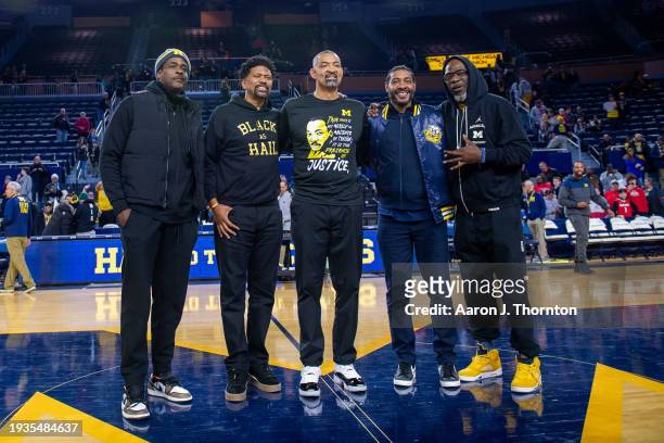 Former Michigan Wolverines "Fab Five" basketball players Chris Webber, Jalen Rose, Juwan Howard, Jimmy King, and Ray Jackson pose at center court...